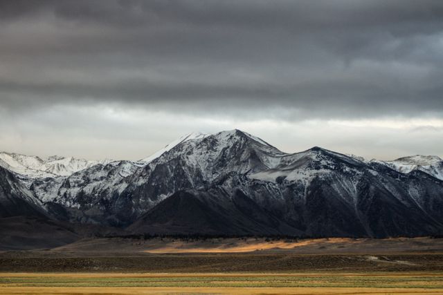 Snow-Capped Mountain Range Under Stormy Sky - Download Free Stock Photos Pikwizard.com