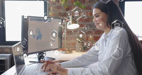 Businesswoman Analyzing Data with Virtual Interface Visuals at Modern Office Desk