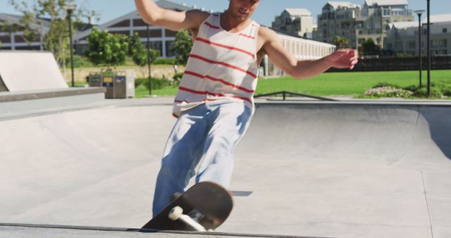 Caucasian man riding and jumping on skateboard on sunny day - Download Free Stock Photos Pikwizard.com