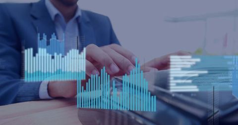 Business analyst typing on laptop with blue data charts and financial dashboard overlay