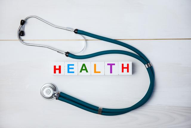 Stethoscope Surrounding Colorful Health Blocks on White Background - Download Free Stock Photos Pikwizard.com