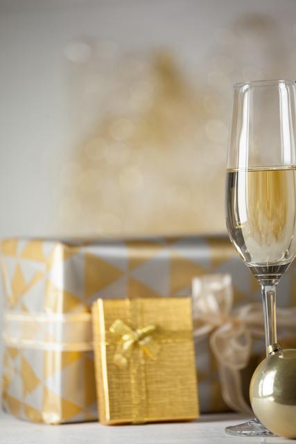 Champagne flute, Christmas gifts and decoration on table
