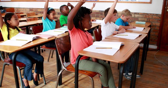 Engaged Schoolchildren Raising Hands in Busy Classroom - Download Free Stock Images Pikwizard.com