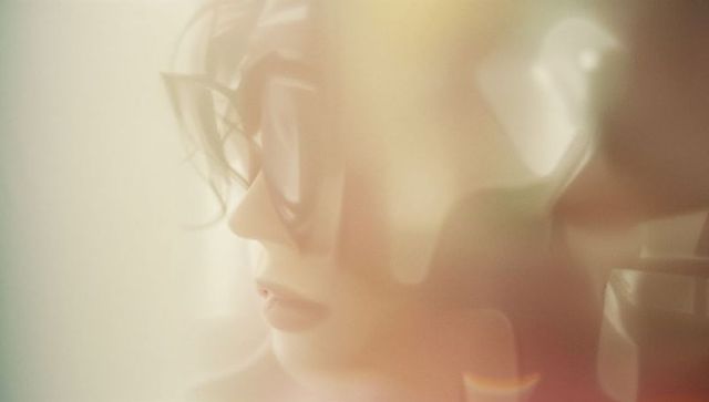 Contemplative Moment: Woman in Oversized Sunglasses With Headphones