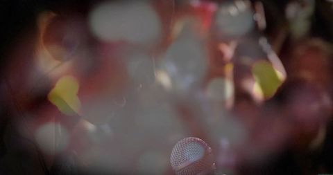 Vibrant concert scene with microphone and bokeh lights