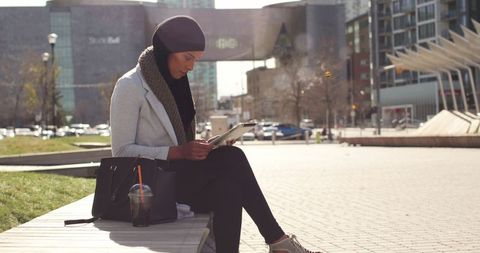 Urban Woman Engaging with Technology on City Bench, Relaxed Lifestyle Concept - Download Free Stock Images Pikwizard.com