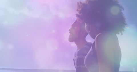 Couple Strolling on Beach with Artistic Light Effect