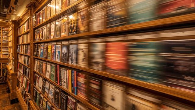 Motion-blur bookstore shelves capturing cozy vintage bookshop aisle with warm lighting
