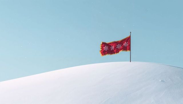 Red decorative flag fluttering on snowy crest with gold trim and snowflakes