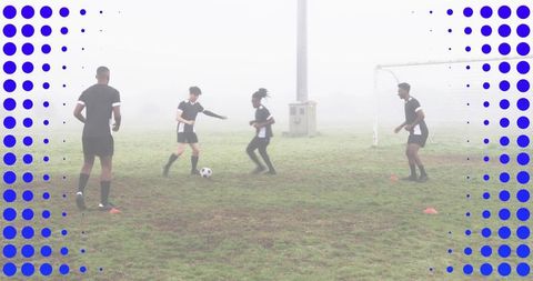Soccer players training on foggy field practicing passing and small-sided drill