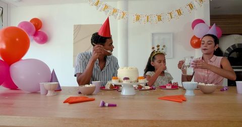 Family Enjoying Birthday Cake Together at Home Celebration
