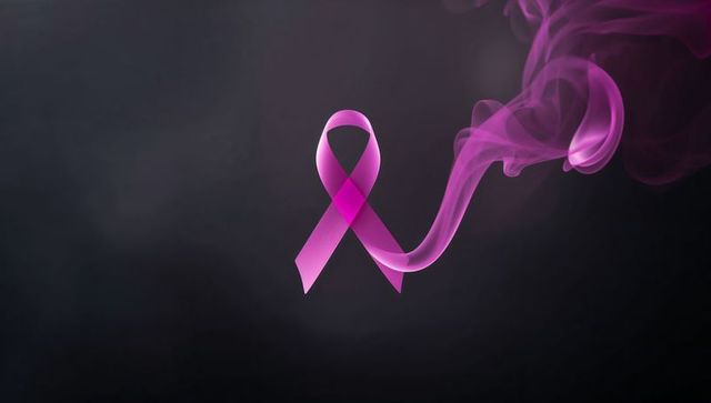 Glowing Pink Awareness Ribbon with Swirling Smoke on Dark Background