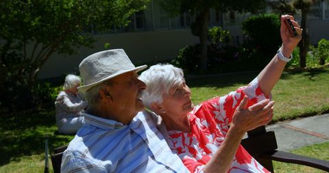 Joyful Senior Couple Taking Selfie in Garden