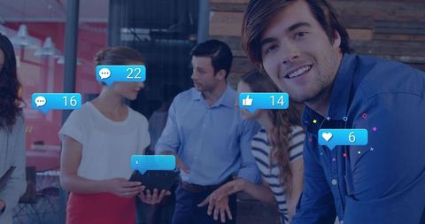 Young professional presenting app demo with social media overlays in collaborative office