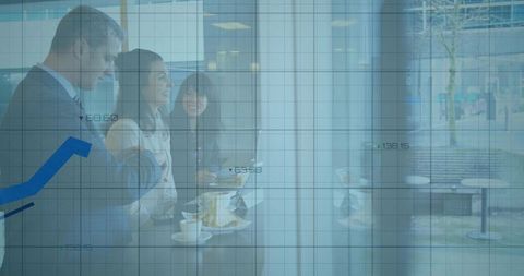Networking colleagues sharing coffee and snacks with laptop and financial chart overlay