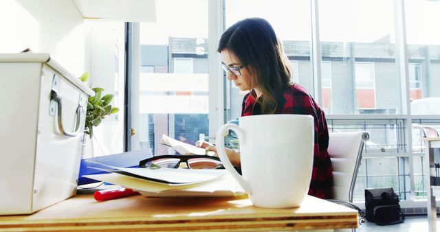 Young Woman Working at Office Desk with Tablet and Coffee Mug - Download Free Stock Images Pikwizard.com