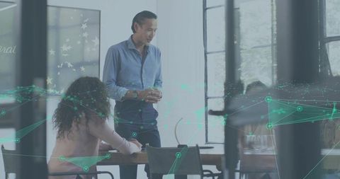 Asian Male Presenting to Team in Modern Glass Office with Teal Digital Network Overlay