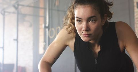 Focused female athlete preparing for workout in gym