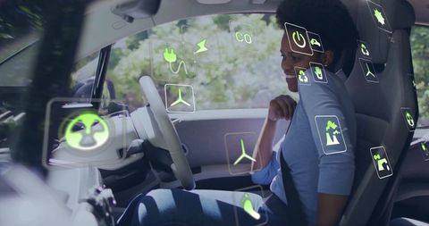 Woman enjoying drive in innovative electric vehicle