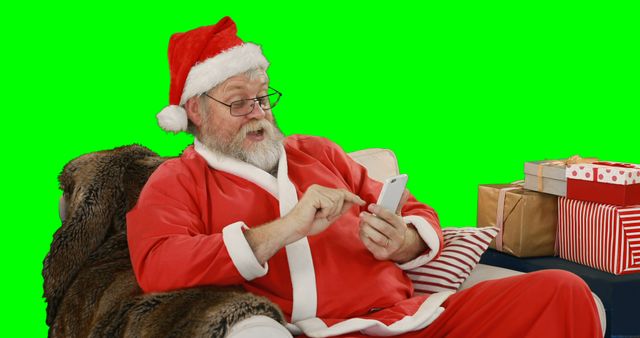 Santa Claus Relaxing and Using Smartphone with Gift Boxes - Download Free Stock Images Pikwizard.com