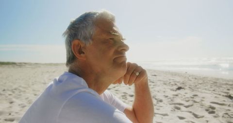 Senior Man Reflecting on Serene Beach Shore - Download Free Stock Images Pikwizard.com