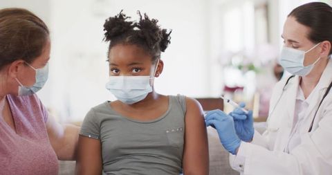 Young Girl Receiving Vaccine from Medical Professional
