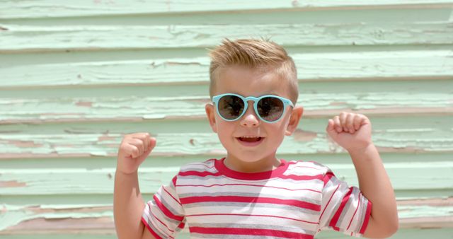 Happy Boy Wearing Sunglasses with Arms Raised - Download Free Stock Images Pikwizard.com