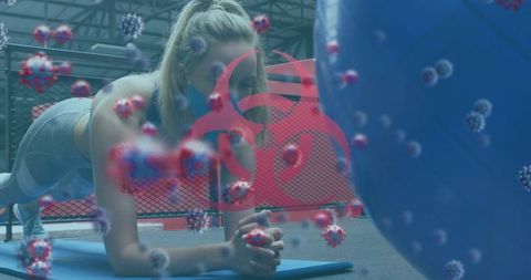 Woman exercising with virus visualization in gym during pandemic