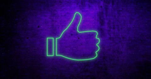 Neon green thumbs up symbol glowing on brick wall