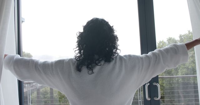 Woman in White Bathrobe Opening Curtains to a Bright Window - Download Free Stock Images Pikwizard.com