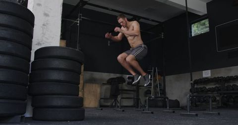 Athletic Man Performing Jump Workout in Gym