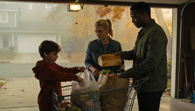 Suburban family unloading groceries in garage at autumn driveway, teamwork moment