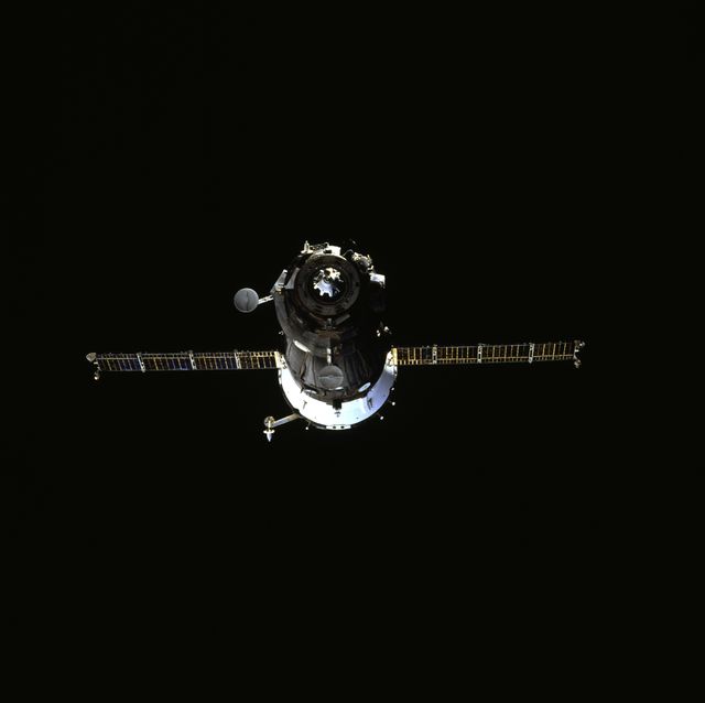 This image captures the Soyuz spacecraft against the dark backdrop of space during the Space Shuttle Atlantis' undocking from the Mir Space Station on July 4, 1995. Ideal for illustrating historic space missions, space technology, and collaboration between NASA and Russia. Suitable for use in educational material, documentaries, and articles about space exploration.