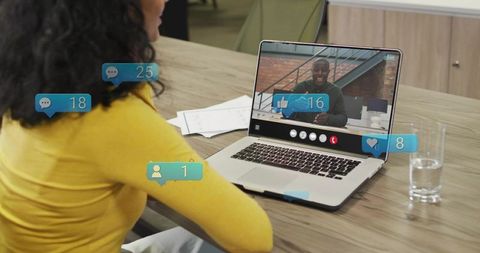 Woman joining remote meeting while social engagement badges appearing on laptop screen