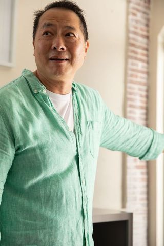 Casually stylish man gesturing in modern living room