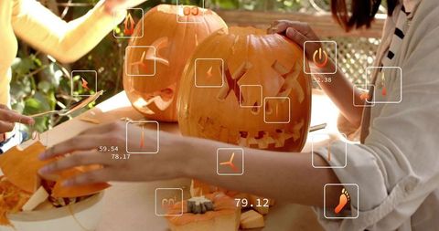 Carving Jack-o'-lanterns on Sunlit Backyard Patio with Augmented Reality Icons