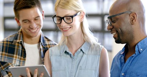 Diverse Colleagues Engaging with Technology in Modern Workspace