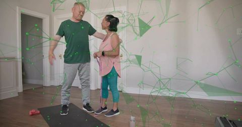Man guiding partner during home resistance band workout for senior rehab, balance support