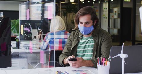 Businessman in Mask Using Smartphone in Modern Office Environment - Download Free Stock Images Pikwizard.com