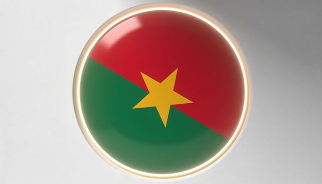 Glossy circular emblem with diagonal red and green background and central yellow star