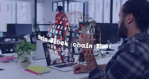 Bearded developer typing on laptop in open office with 3D blockchain globe overlay