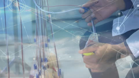 Caucasian Doctor Adjusting Intravenous Drips with Digital Connection Network