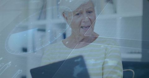 Senior woman exploring digital technology on laptop with futuristic hud overlay