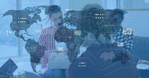Global team discussing data analytics with interactive world map overlay on laptop screen