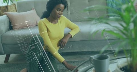 Woman Practicing Mindfulness and Relaxation at Home with Yoga Wheel