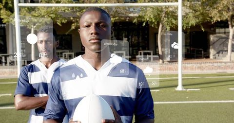 Confident young athlete holding oval ball on sunlit turf with augmented reality weather hud