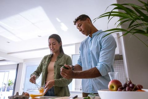 Diverse Couple Cooking Together in Modern Kitchen with Fresh Produce