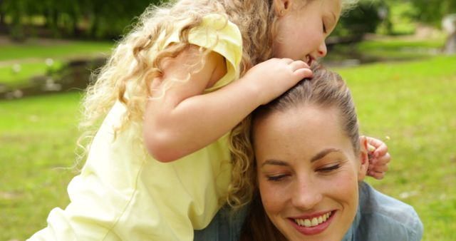 Smiling mother and daughter enjoying playful moment in park - Download Free Stock Images Pikwizard.com