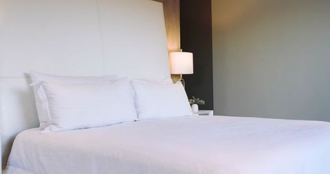 Minimalist white bedding in modern tranquil bedroom decor