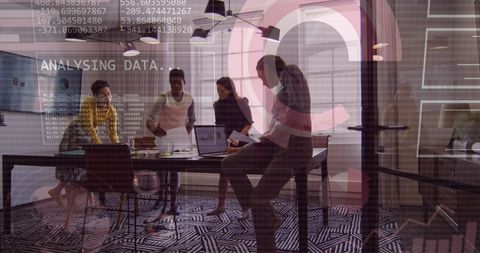 Diverse Group Analyzing Financial Data in Modern Office Setting